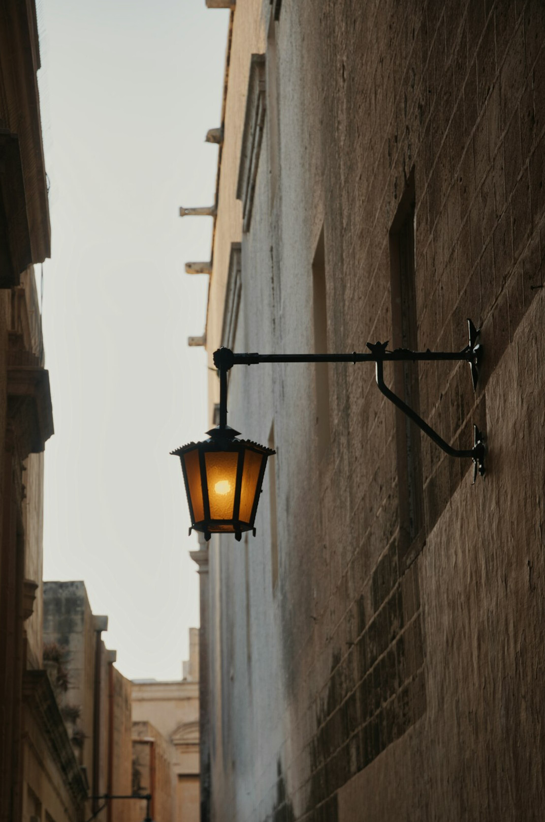 Foggy old city street with wrought iron lamp post