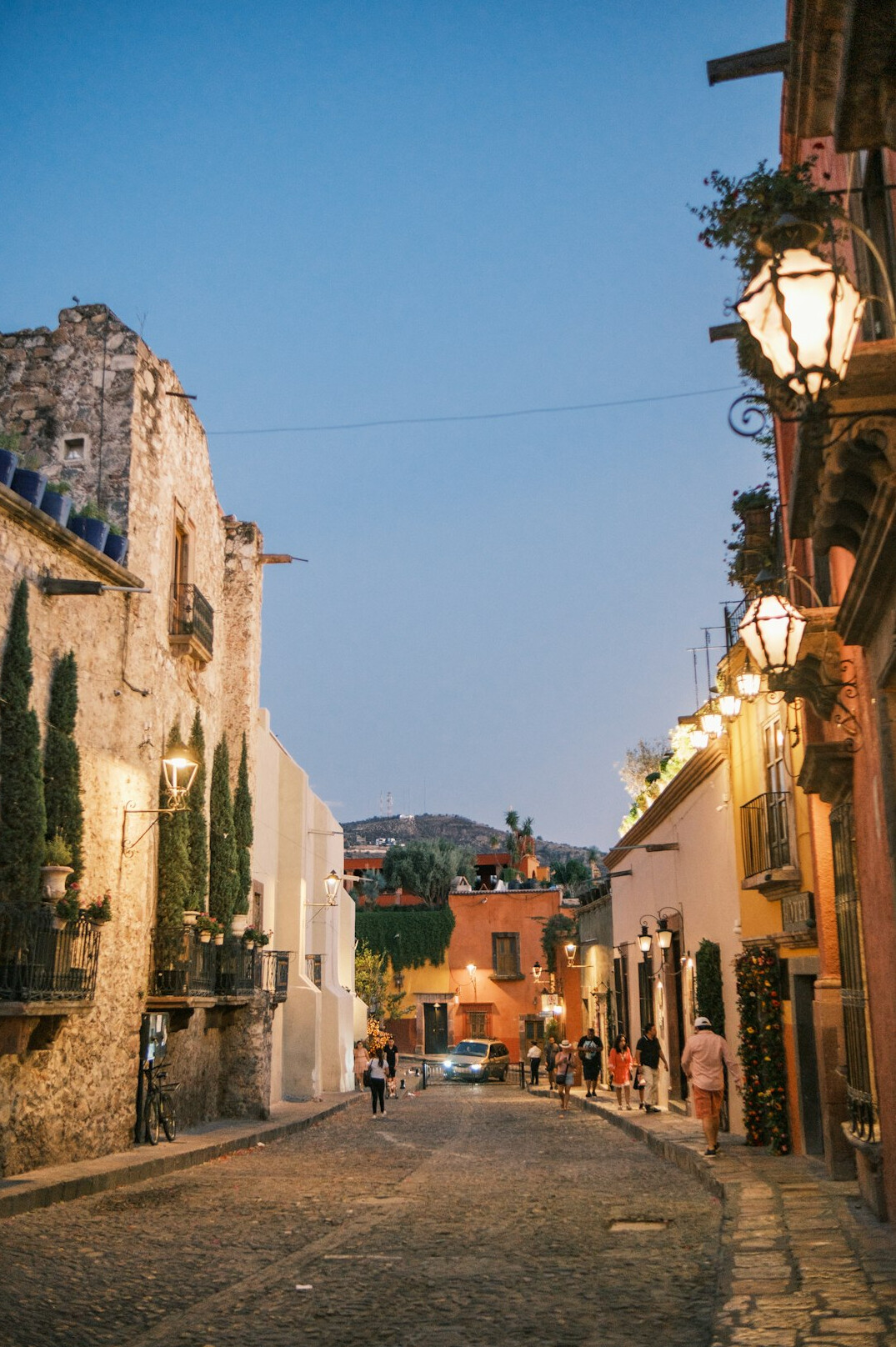 Narrow cobblestone street at dusk in an old South American city