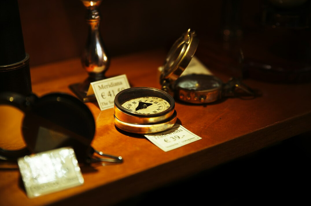 Old map spread on a wooden table with a compass